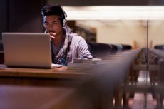 A student studying and working on a laptop.