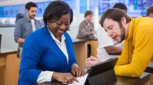 Microsoft store associate working with a teacher