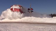 The train ploughs through a mound of snow showing that whatever the weather, the show must go on